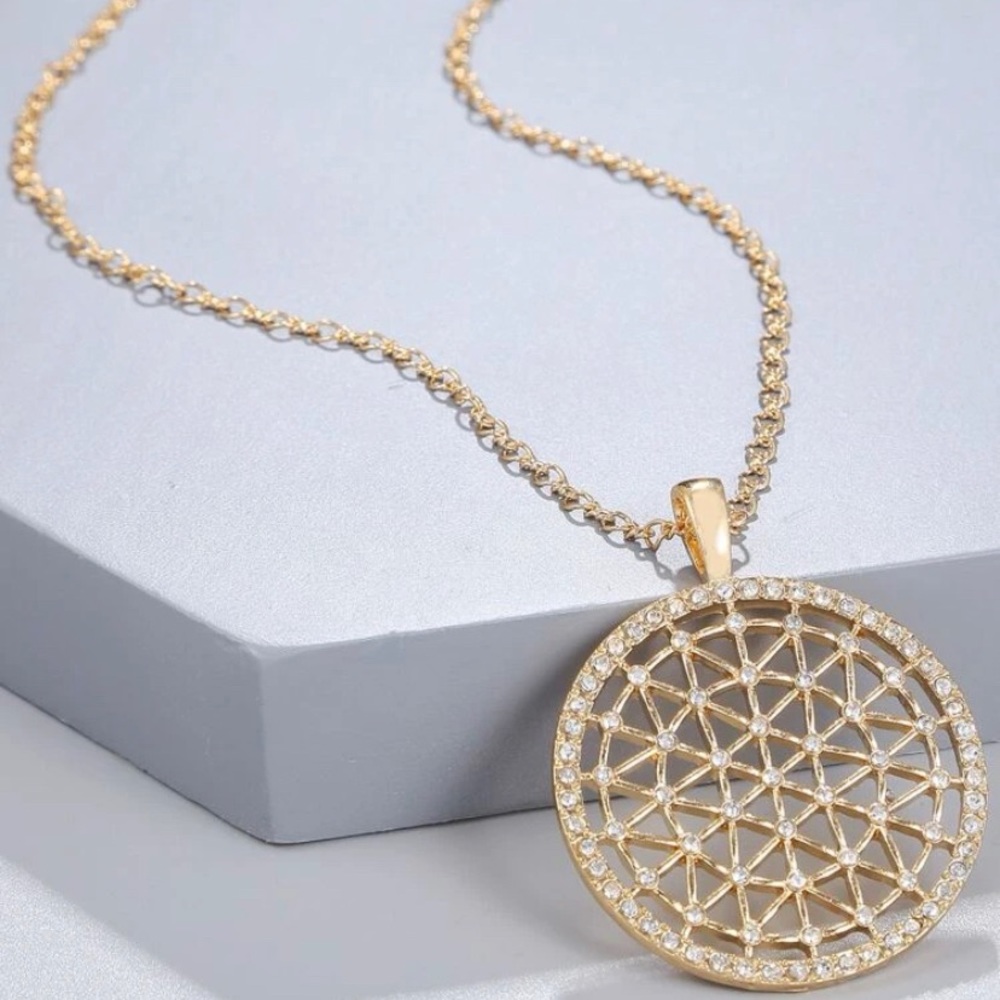 Gold necklace with gold and rhinestones pendant.